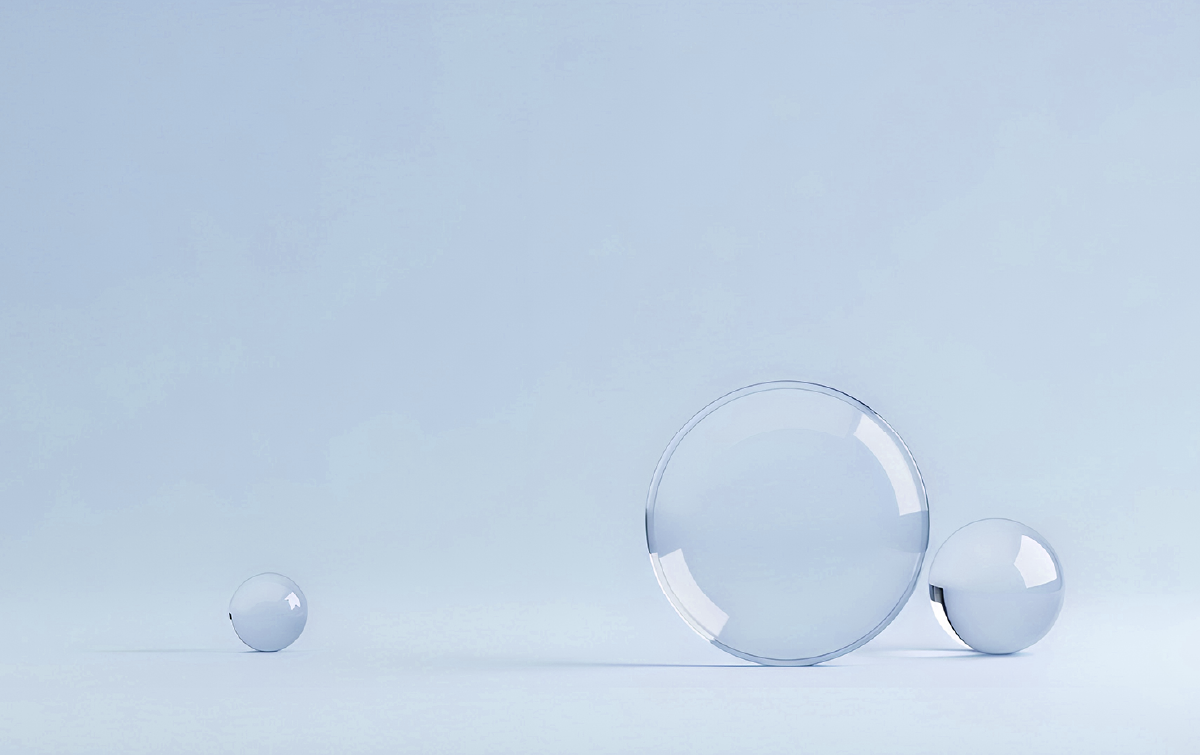 Minimalist image of three translucent glass spheres on a white background
