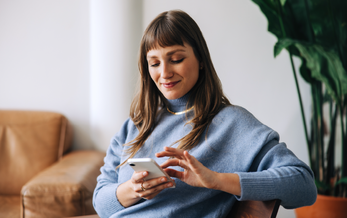 Person using a smartphone to access information, representing simple, user-friendly access to enterprise data.